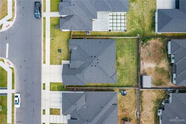 an aerial view of a house with a yard swimming pool and outdoor seating