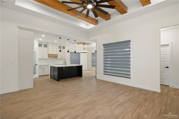 a large white kitchen with a sink and cabinet