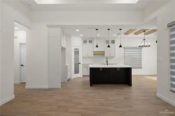 a view of kitchen with stainless steel appliances cabinets and wooden floor