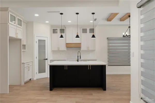 a kitchen with stainless steel appliances granite countertop a sink and a refrigerator