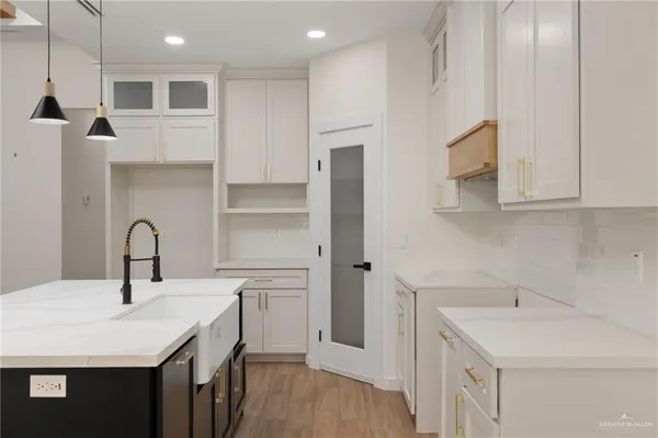 a kitchen with a sink a stove and cabinets