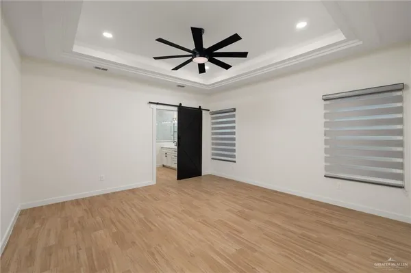 a view of a livingroom with a ceiling fan and wooden floor