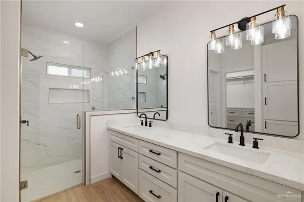 a bathroom with a double vanity sink mirror and double