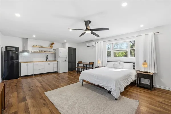 a bedroom with a bed and a chandelier