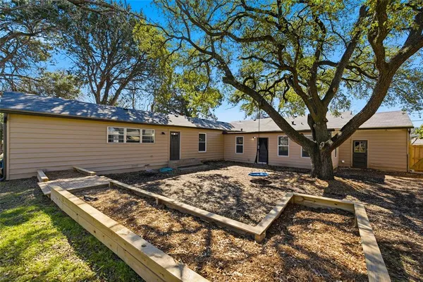 a view of a backyard with a large tree