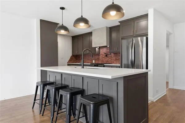 a kitchen with stainless steel appliances kitchen island a chandelier