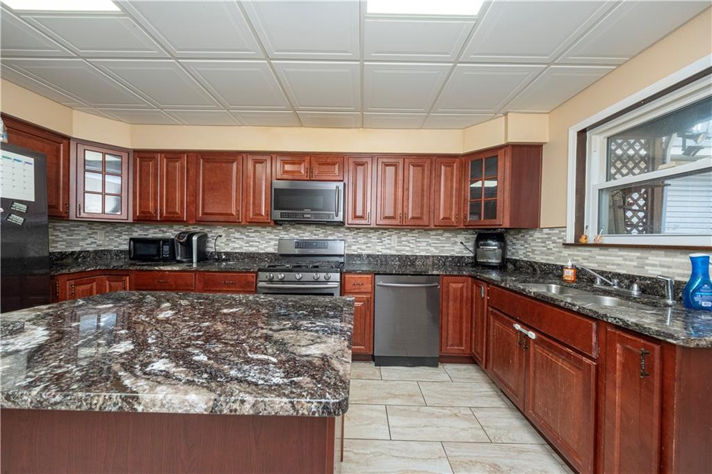 33 5th Street Pittsburgh, PA 15215 - Photo 11 of 32 a kitchen with stainless steel appliances granite countertop a stove sink and cabinets