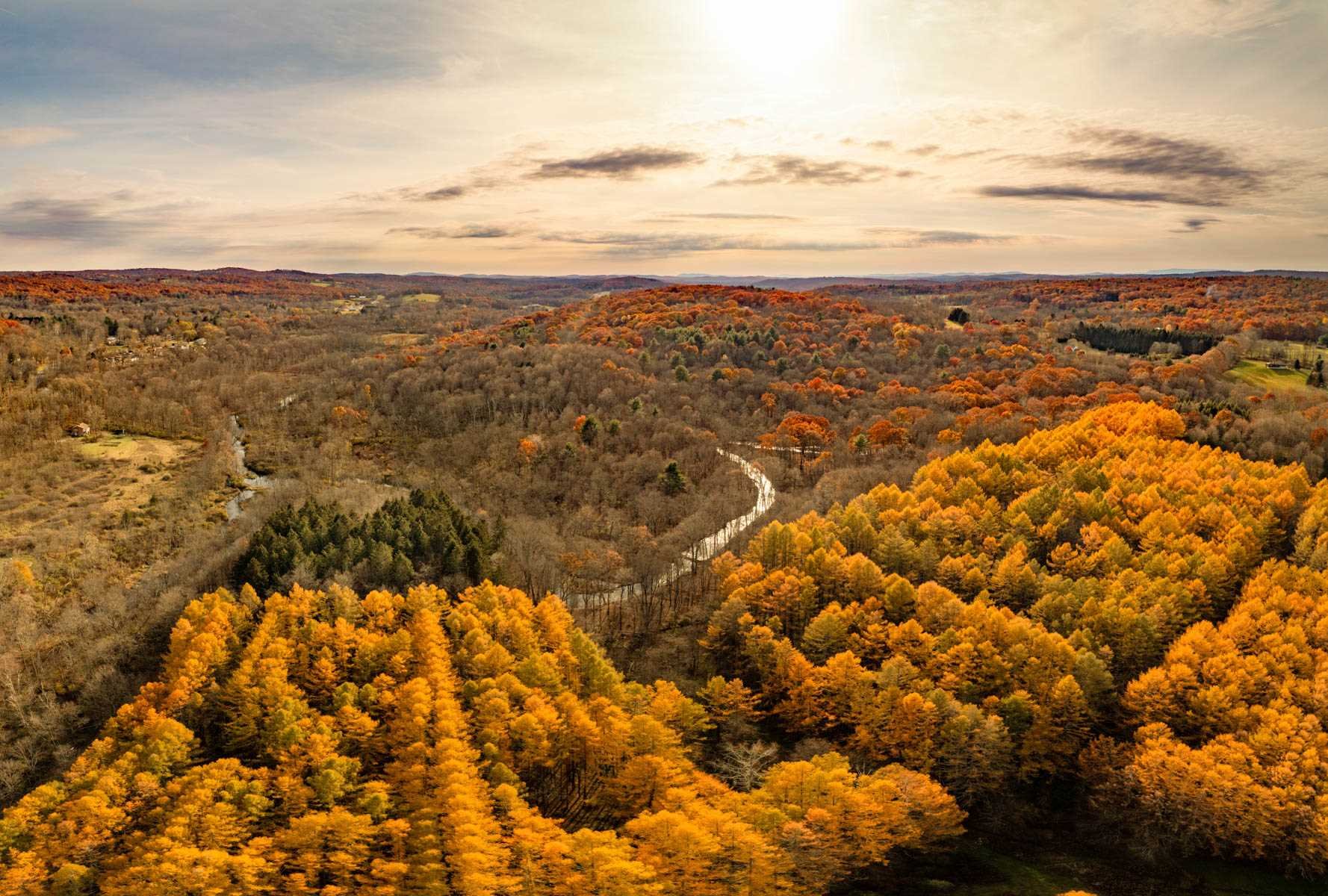 an aerial view of house with yard and mountain view in back