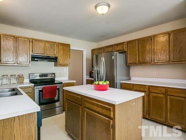 5709 Edgebury Road Raleigh, NC 27613 - Photo 11 of 20 a kitchen that has a sink and a stove in it