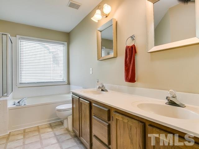 5709 Edgebury Road Raleigh, NC 27613 - Photo 14 of 20 a bathroom with a sink and a bathtub