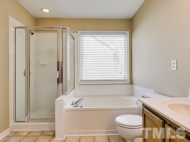 5709 Edgebury Road Raleigh, NC 27613 - Photo 15 of 20 a bathroom with a bathtub toilet and shower