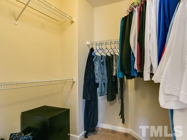 5709 Edgebury Road Raleigh, NC 27613 - Photo 16 of 20 a view of walk in closet with clothes and shoes