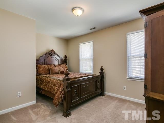 5709 Edgebury Road Raleigh, NC 27613 - Photo 17 of 20 a room with a bed and a window