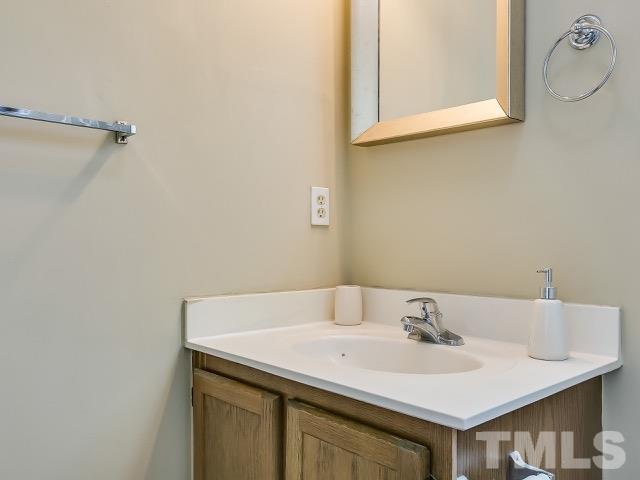 5709 Edgebury Road Raleigh, NC 27613 - Photo 18 of 20 a bathroom with a sink and a mirror