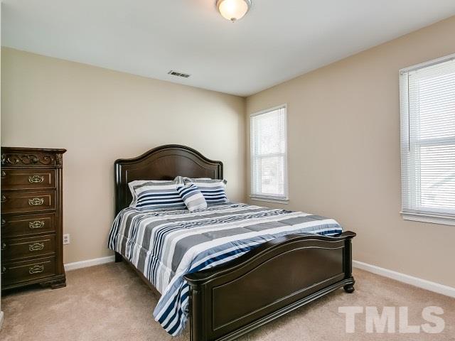 5709 Edgebury Road Raleigh, NC 27613 - Photo 19 of 20 a bedroom with a bed and a window
