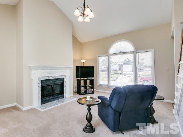 5709 Edgebury Road Raleigh, NC 27613 - Photo 7 of 20 a living room with furniture and a fireplace