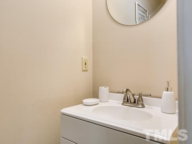 5709 Edgebury Road Raleigh, NC 27613 - Photo 8 of 20 a white bathroom with a sink and a mirror