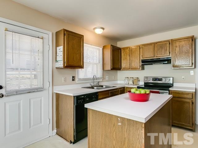 5709 Edgebury Road Raleigh, NC 27613 - Photo 10 of 20 a kitchen with a stove a sink and a refrigerator