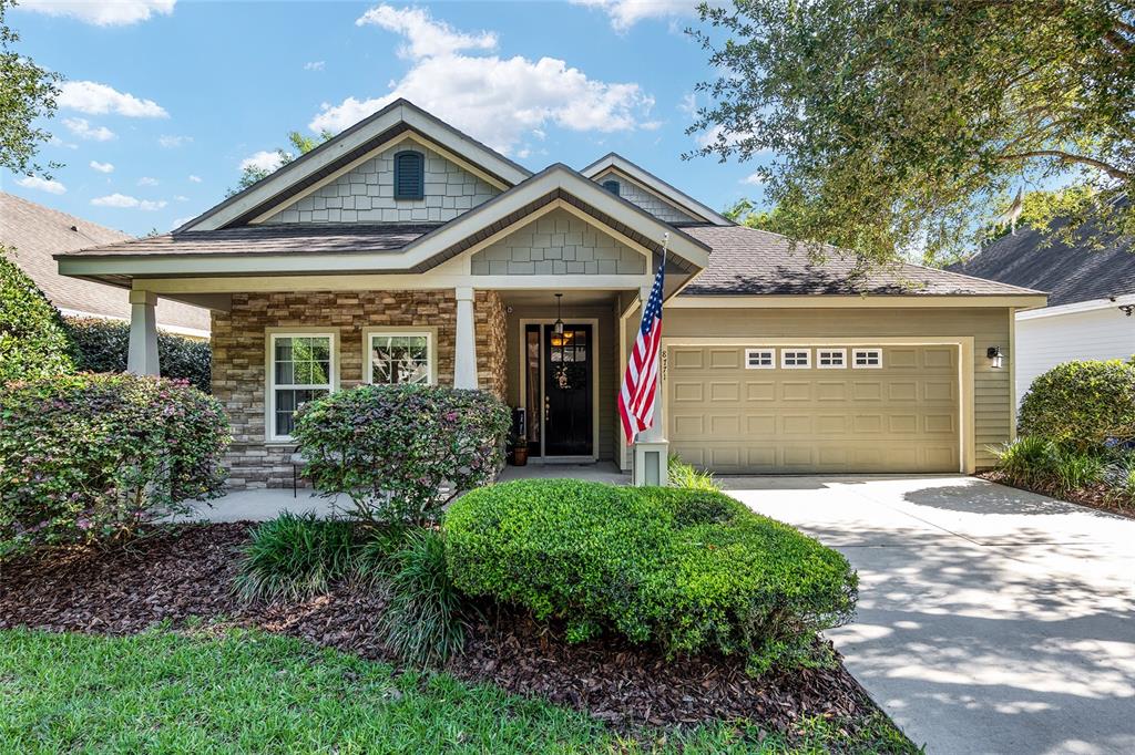 8771 Southwest 25 Road Gainesville, FL 32608 - Photo 1 of 1 a view of a house with a small yard and a large tree