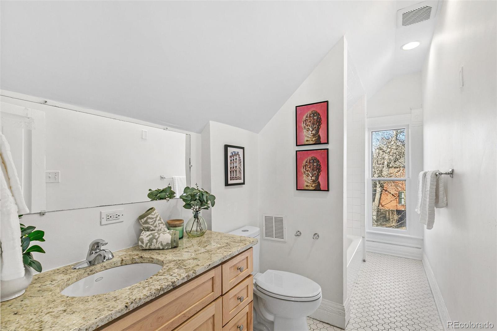 3885 Wolff Street Denver, CO 80212 - Photo 33 of 50 a bathroom with a granite countertop sink a toilet and a large mirror