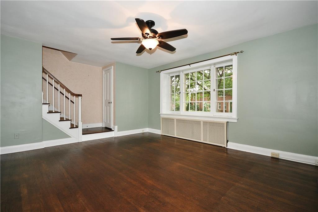 452 Sulgrave Road Pittsburgh, PA 15211 - Photo 2 of 25 a view of an empty room with wooden floor and a window