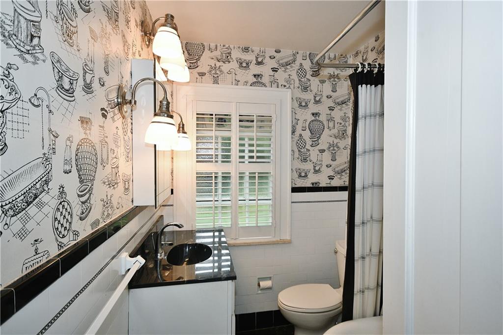 452 Sulgrave Road Pittsburgh, PA 15211 - Photo 14 of 25 a bathroom with a toilet and a shower curtain