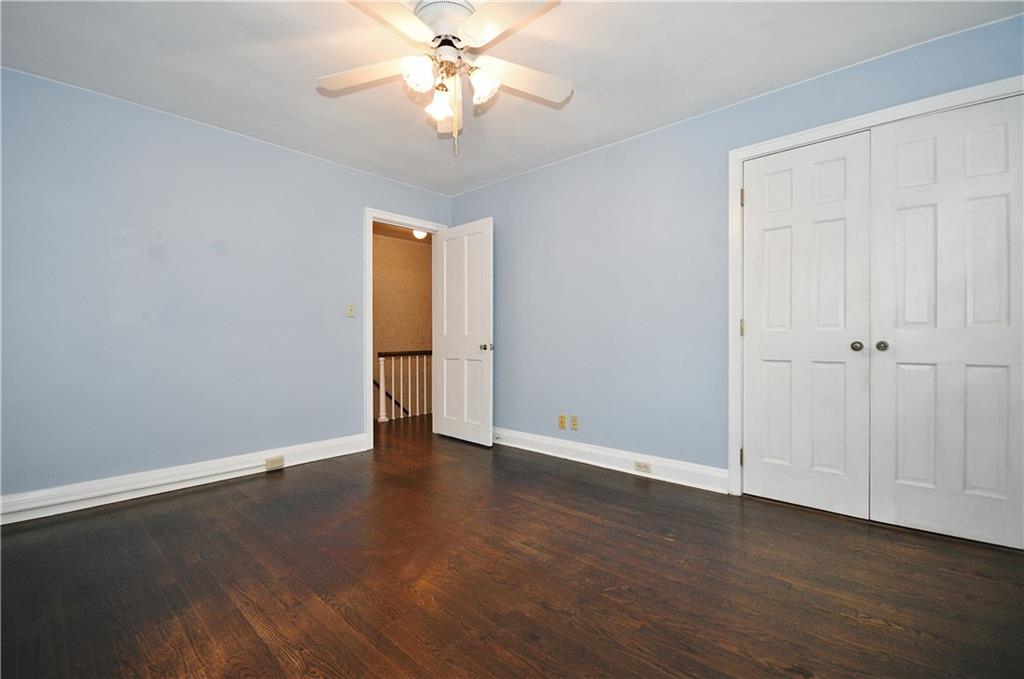 452 Sulgrave Road Pittsburgh, PA 15211 - Photo 17 of 25 an empty room with wooden floor fan and windows