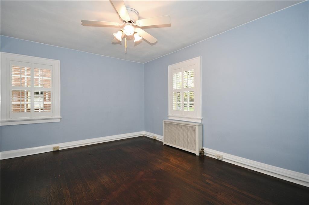 452 Sulgrave Road Pittsburgh, PA 15211 - Photo 18 of 25 a view of an empty room with wooden floor and a window