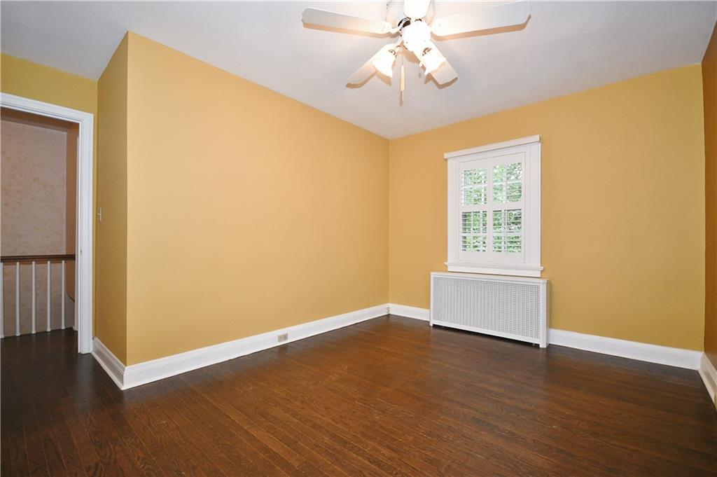 452 Sulgrave Road Pittsburgh, PA 15211 - Photo 19 of 25 a view of a livingroom with wooden floor and a ceiling fan
