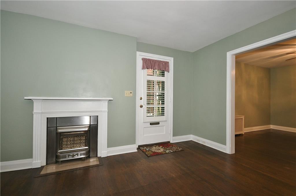 452 Sulgrave Road Pittsburgh, PA 15211 - Photo 5 of 25 a view of an empty room with a fireplace and a window