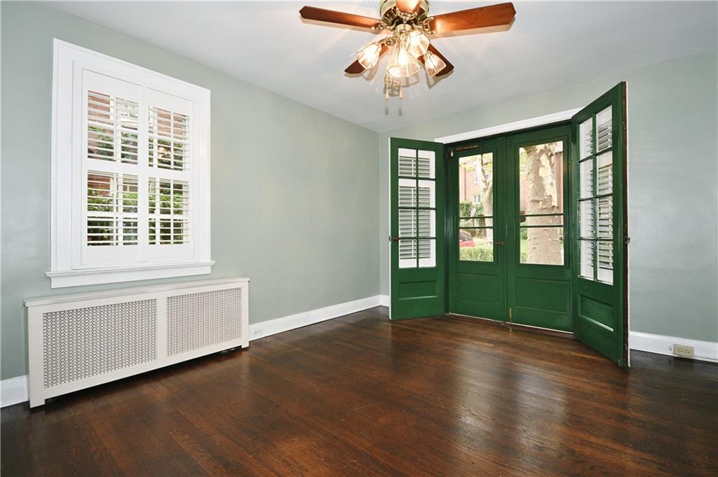 452 Sulgrave Road Pittsburgh, PA 15211 - Photo 7 of 25 a view of an empty room with wooden floor and a window