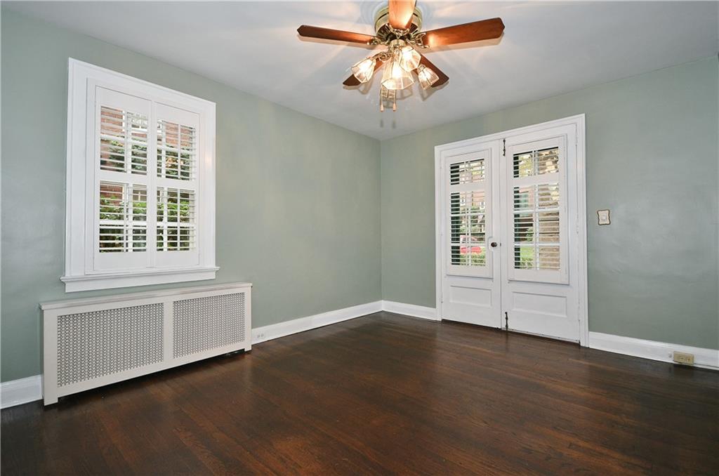 452 Sulgrave Road Pittsburgh, PA 15211 - Photo 8 of 25 a view of an empty room with wooden floor and a window