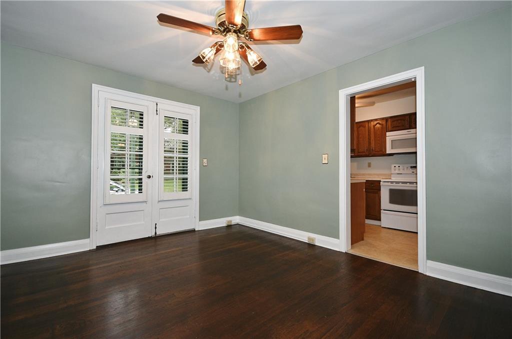 452 Sulgrave Road Pittsburgh, PA 15211 - Photo 9 of 25 a view of an empty room with wooden floor and a window