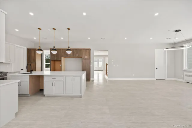 a large kitchen with cabinets and wooden floor