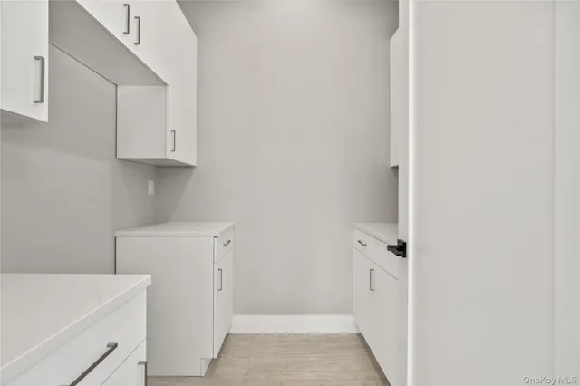 a view of walk in closet with white cabinet