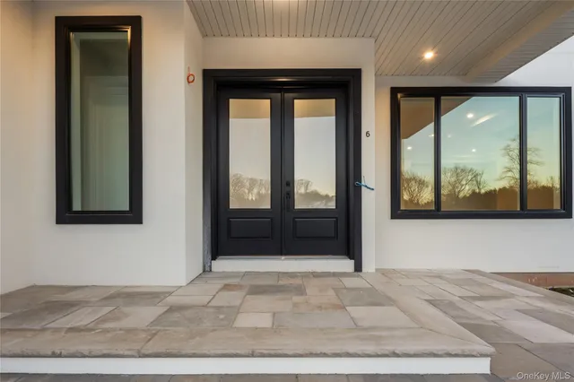 a view of a hallway with wooden floor and door