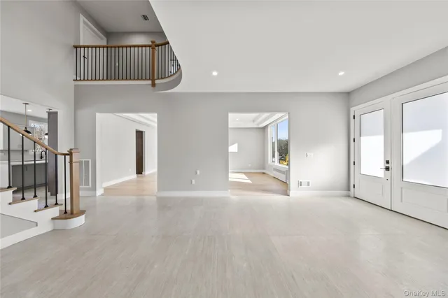 a view of a livingroom with wooden floor and staircase