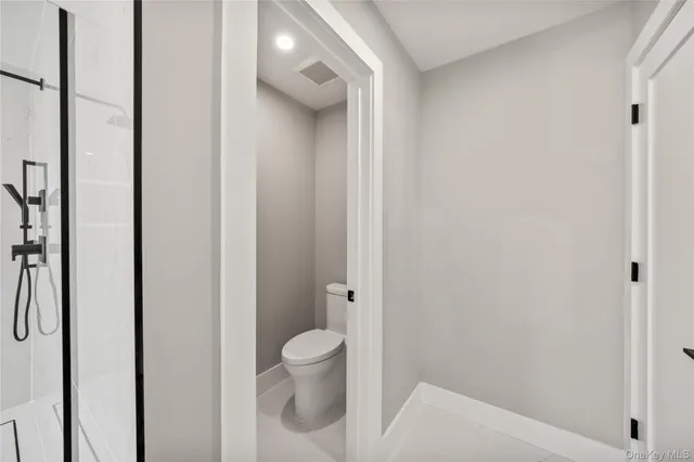 a white toilet sitting next to a bathroom sink