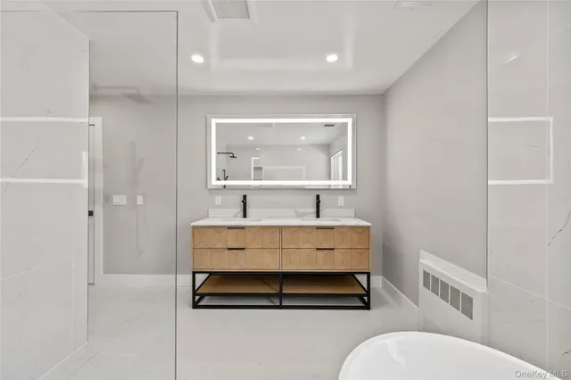 a bathroom with a sink mirror vanity and toilet