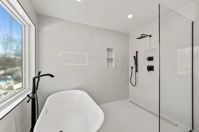 a bathroom with a bathtub and shower