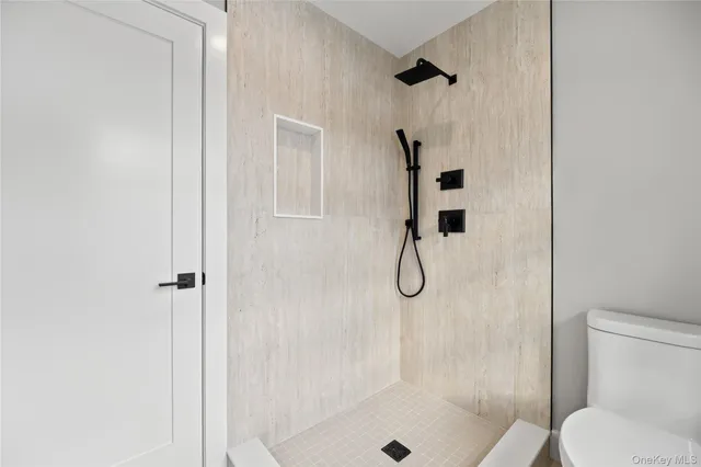 a bathroom with a shower and toilet