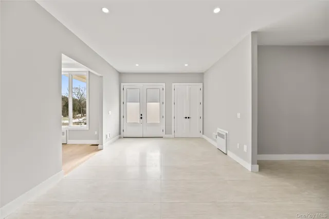 an empty room with windows and closet