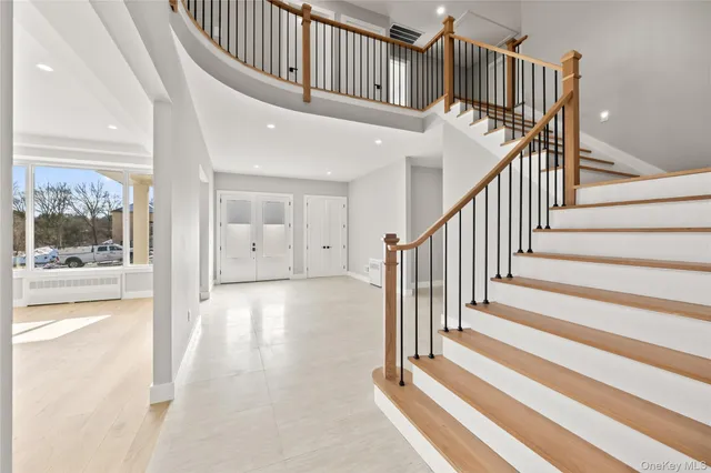 a view of staircase with white walls and a next to a window
