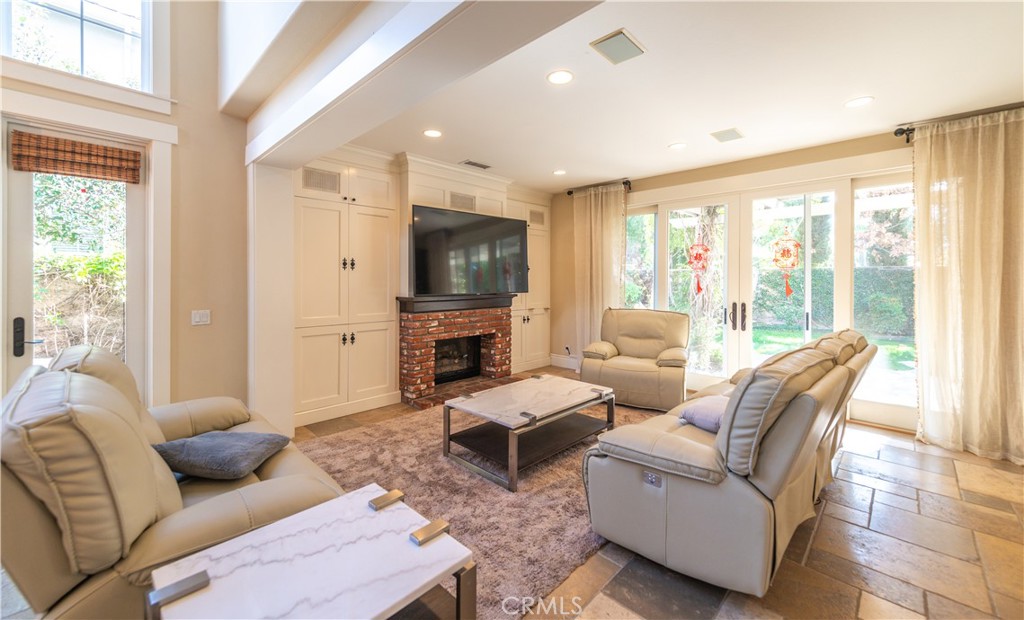 4 Whispering Pine Irvine, CA 92620 - Photo 4 of 13 a living room with furniture a large window and a flat screen tv