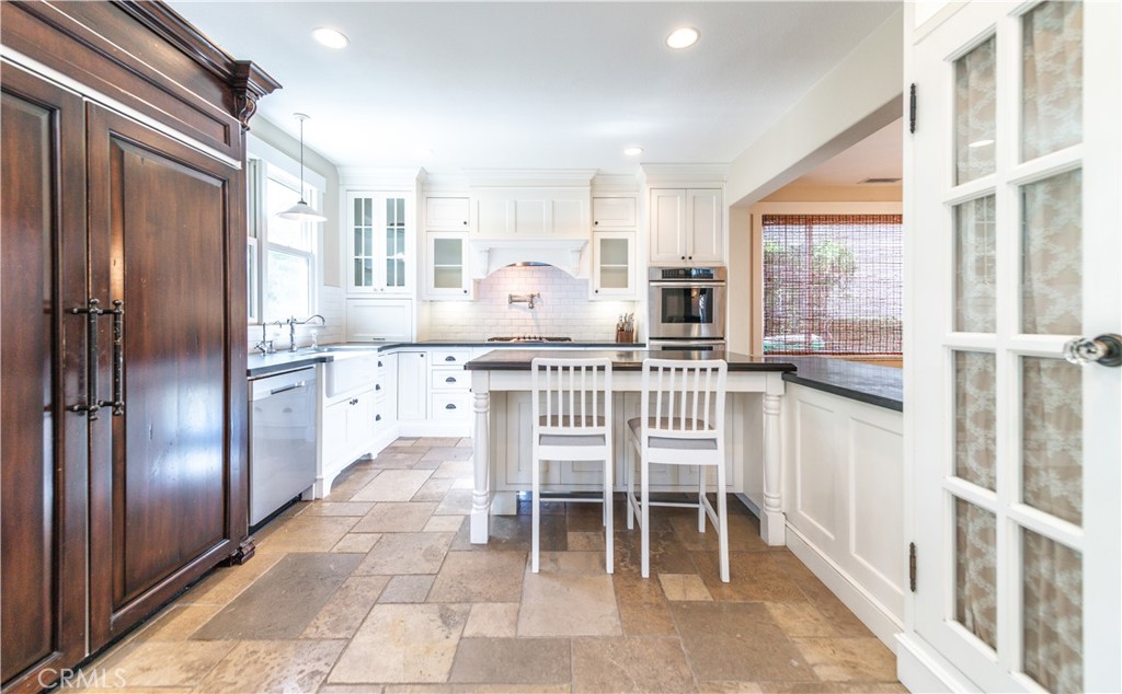 4 Whispering Pine Irvine, CA 92620 - Photo 6 of 13 a kitchen with granite countertop a refrigerator and furniture
