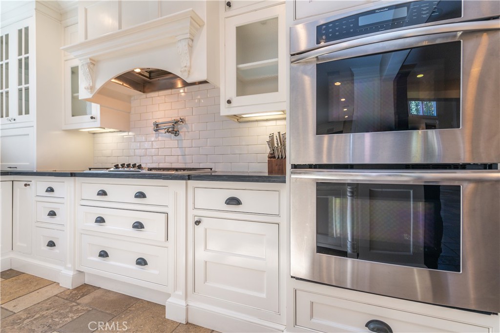 4 Whispering Pine Irvine, CA 92620 - Photo 7 of 13 a kitchen with granite countertop white cabinets and white appliances