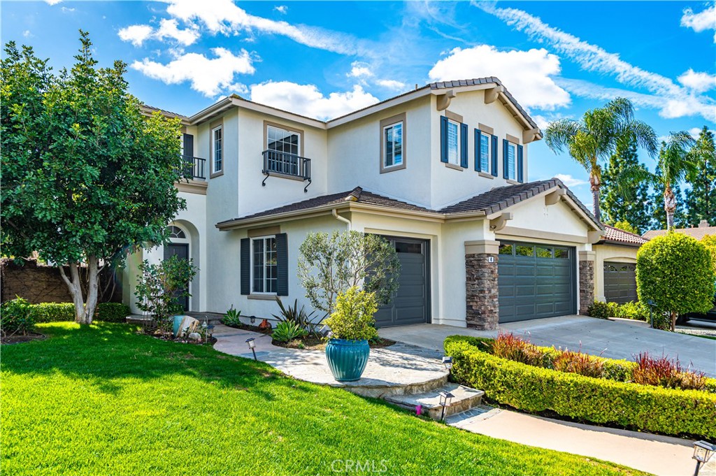 4 Whispering Pine Irvine, CA 92620 - Photo 9 of 13 a front view of a house with a yard and porch