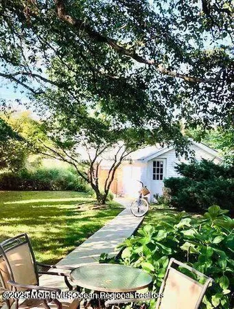 a backyard of a house with outdoor seating