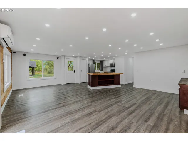 a view of kitchen and hall with wooden floor