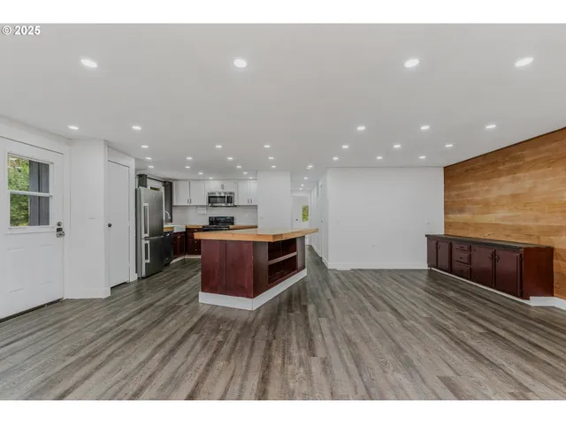 a kitchen with a refrigerator and a counter top space